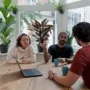 woman in white shirt sitting beside man in red crew neck t-shirt